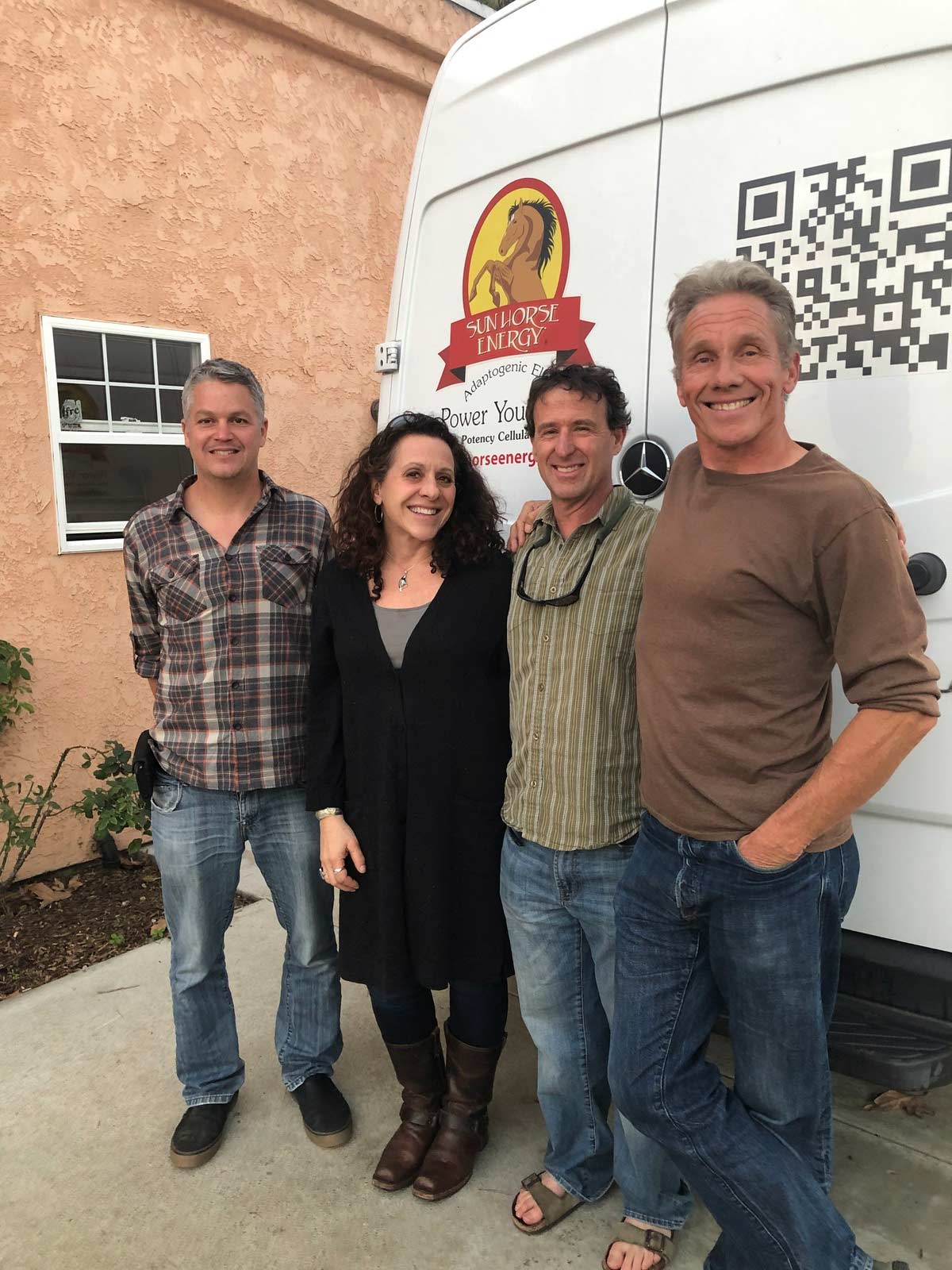 CBD Garage’s Catherine Greener and Alan Greenberg standing together outside with Justin Marvonek and Dan Moriaty from Sun Horse Energy.