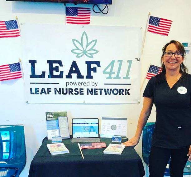 Katherine stands smiling at the Leaf411 informational table, ready to help veterans with their questions. Katherine a fully-licensed cannabis-trained nurse.