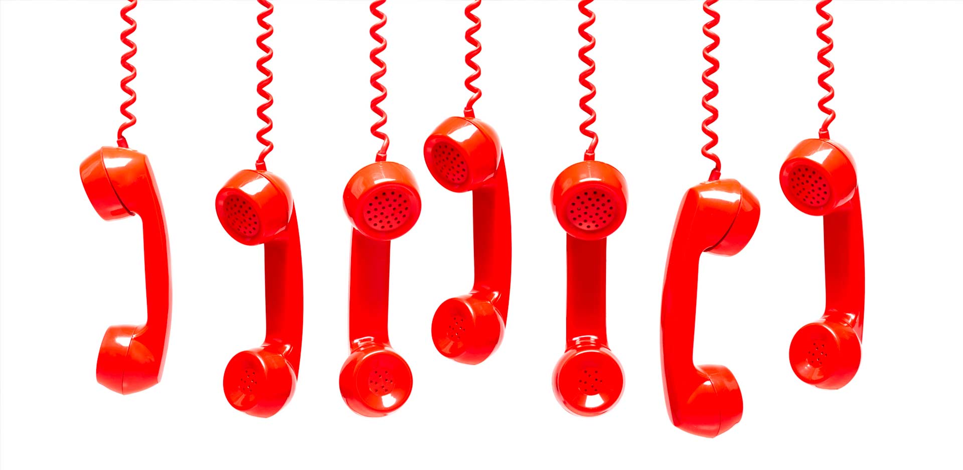 Old-fashioned red telephone handsets representing busy COVID-19 hotlines.