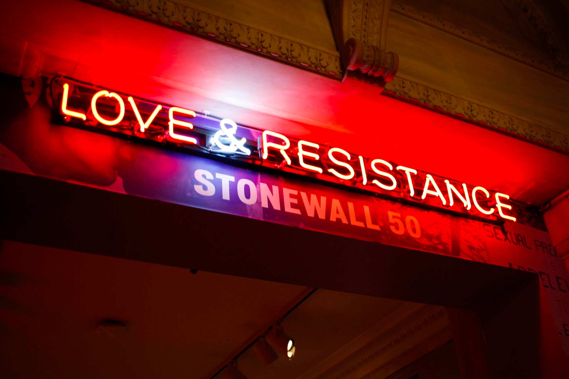 Neon sign outside of the historic Stonewall Inn that says, “Love & Resistance, Stonewall 50.” LGBTQ+ people of color played a pivotal role in the Stonewall uprising.