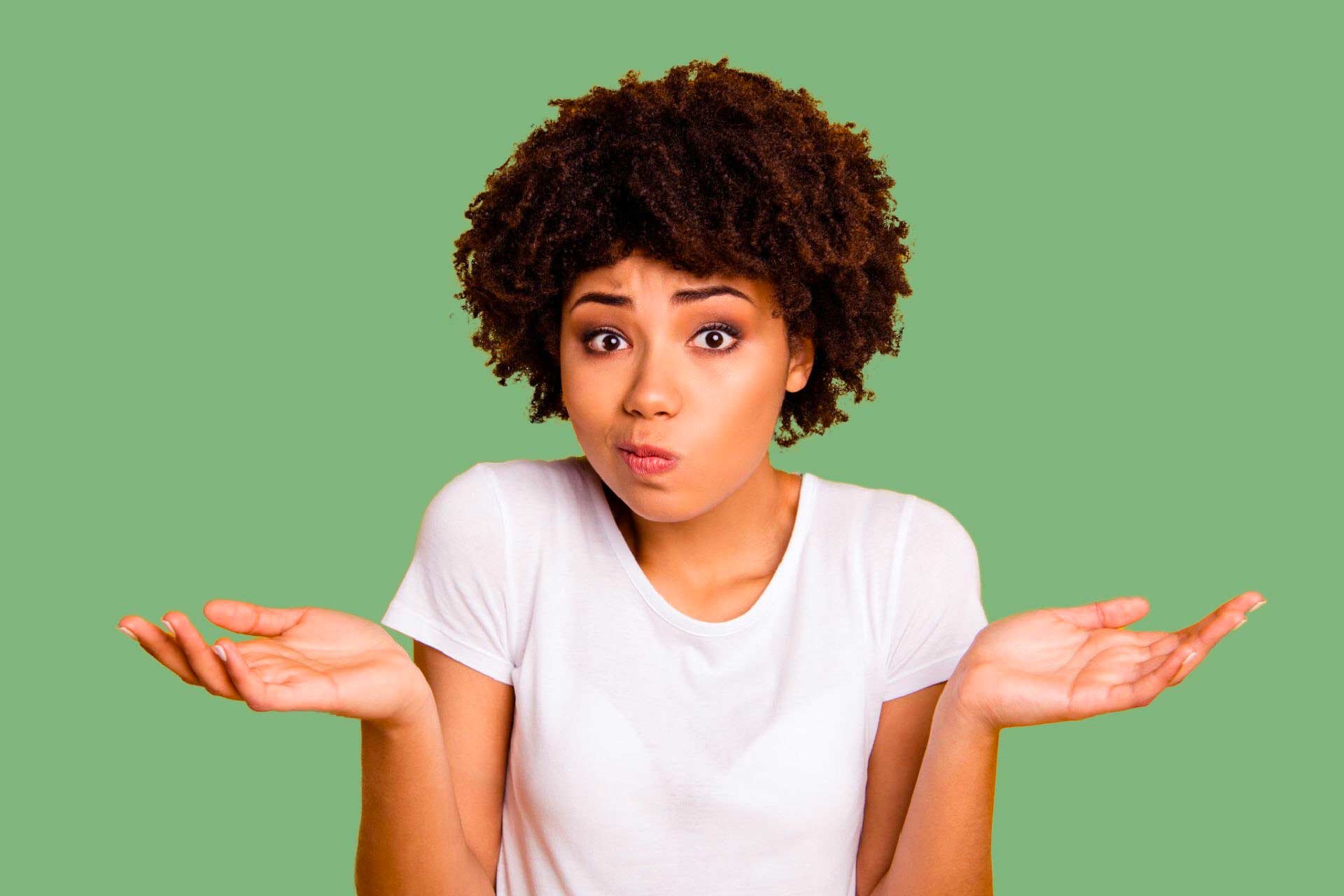 Young Black woman with questioning face shrugging, unsure which cannabis product to buy.