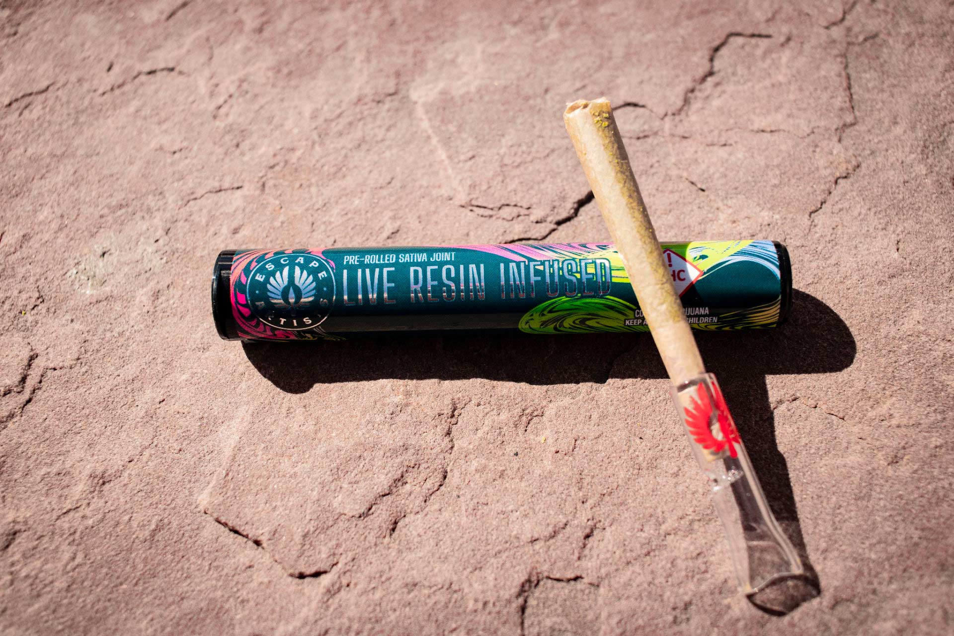 Escape Artists Live Resin preroll shown with packaging and included glass tip