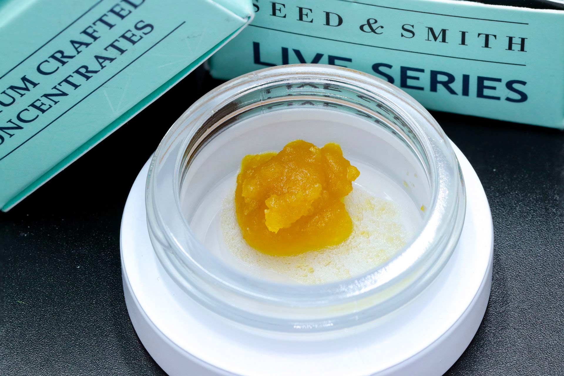 Seed & Smith live resin concentrate in a jar with packaging in background.