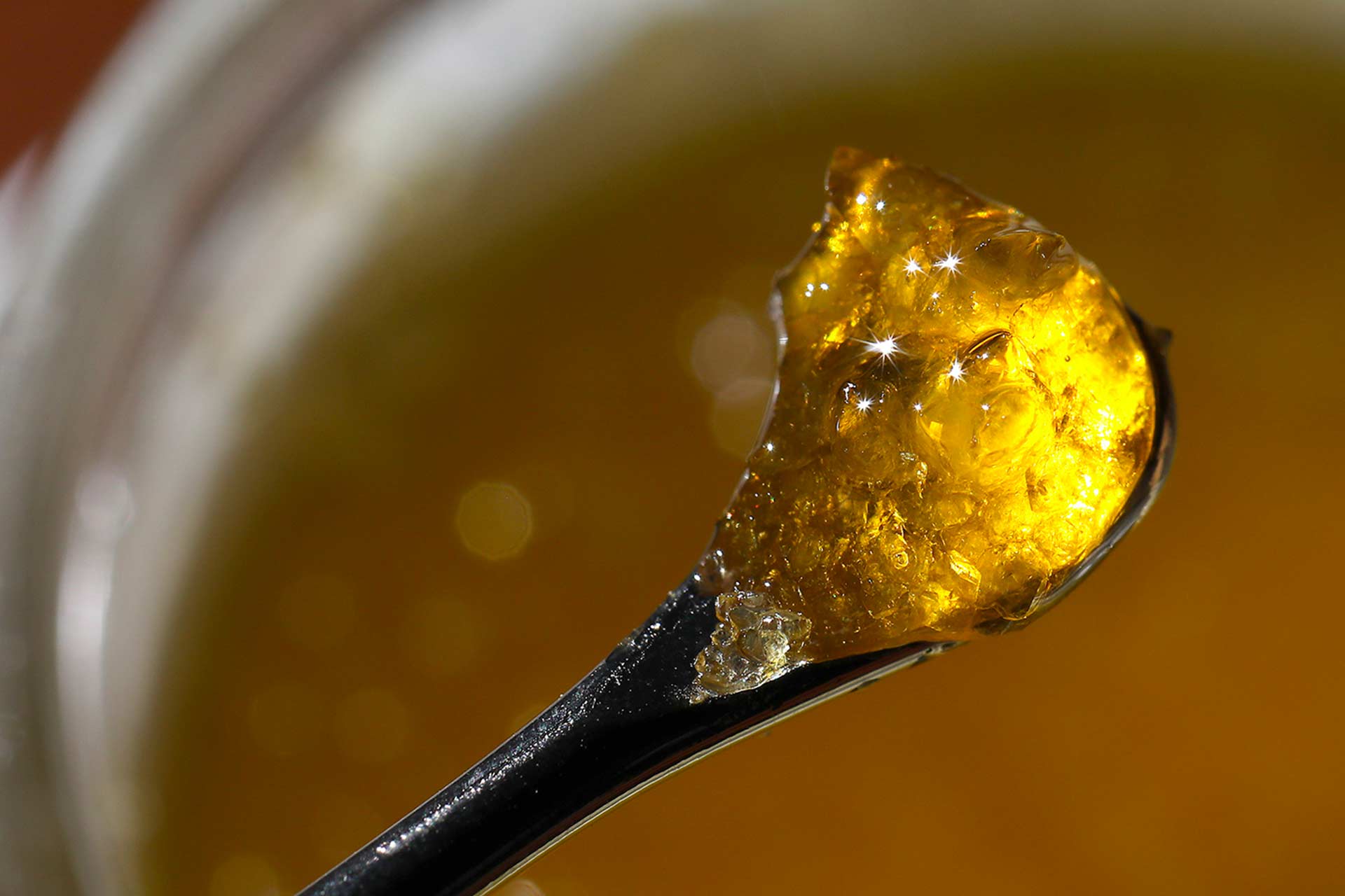 Seed & Smith live resin cannabis concentrate shown on the end of a dabber scoop.