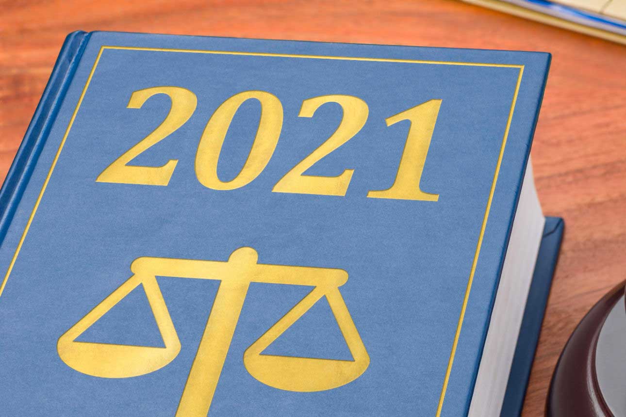 Changing Delta-8 laws represented by book with scales of justice and “2021” printed on cover and a court gavel.