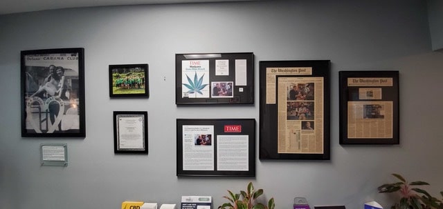 Framed photos and news articles covering Takoma Wellness Center’s work in the Washington, D.C. area.