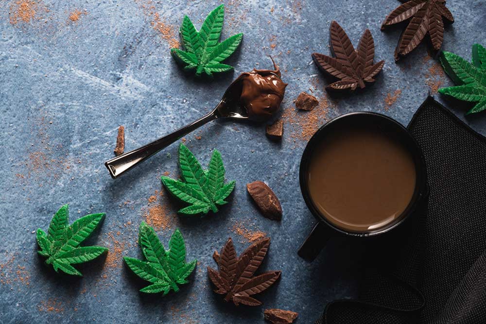 Cannabis chocolate edibles that contain THC, molded into the shape of a cannabis leaf.