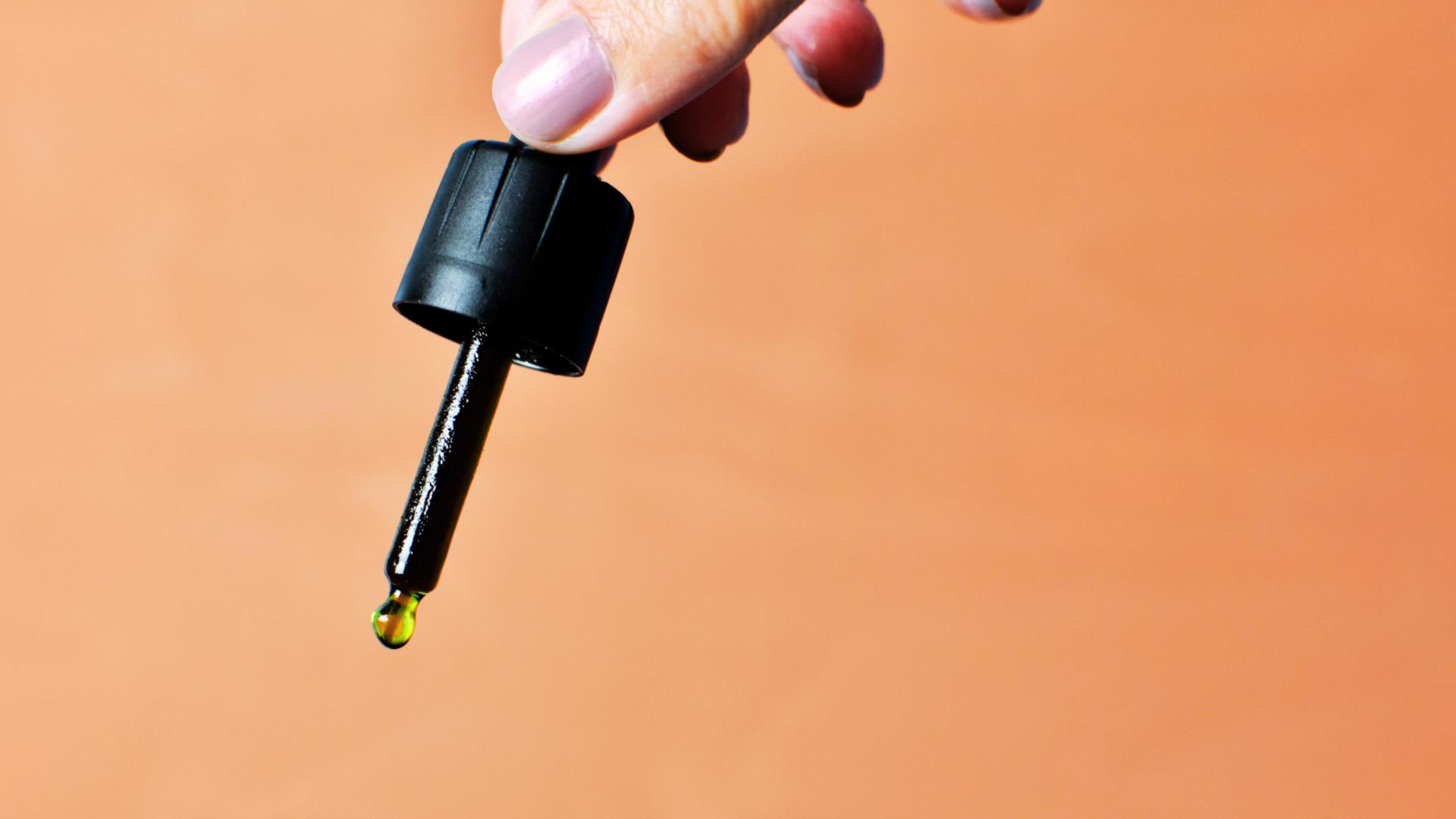 Cannabis oil tincture dropper measuring out CBD oil